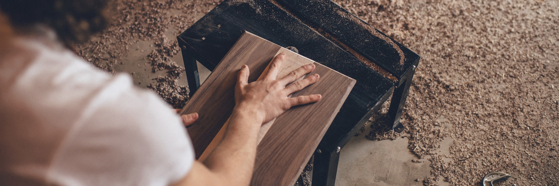 Photo by Ian Schneider on Unsplash A person handling a piece of wood.